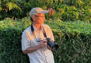 Conrad Siers, with a Sony camera in hand, surveys a scene.
