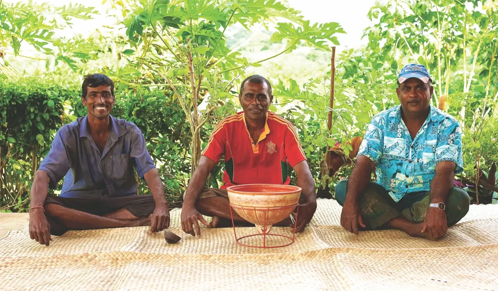 Neighbours sharing an afternoon grog session, using a repurposed fishing float as a basin, Fiji